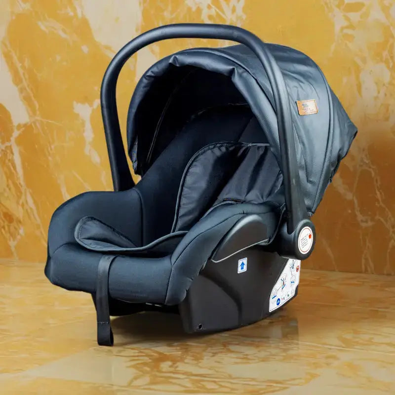 Black Lucid SENA infant car seat shown against a warm brown backdrop