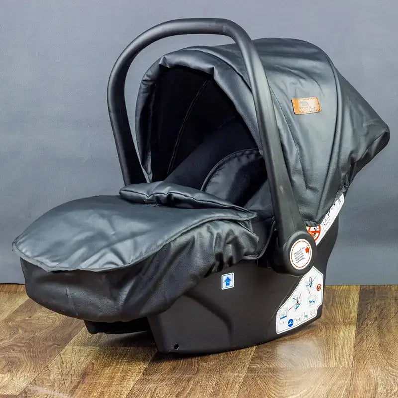 Black Lucid SENA infant car seat with fitted leg cover and canopy