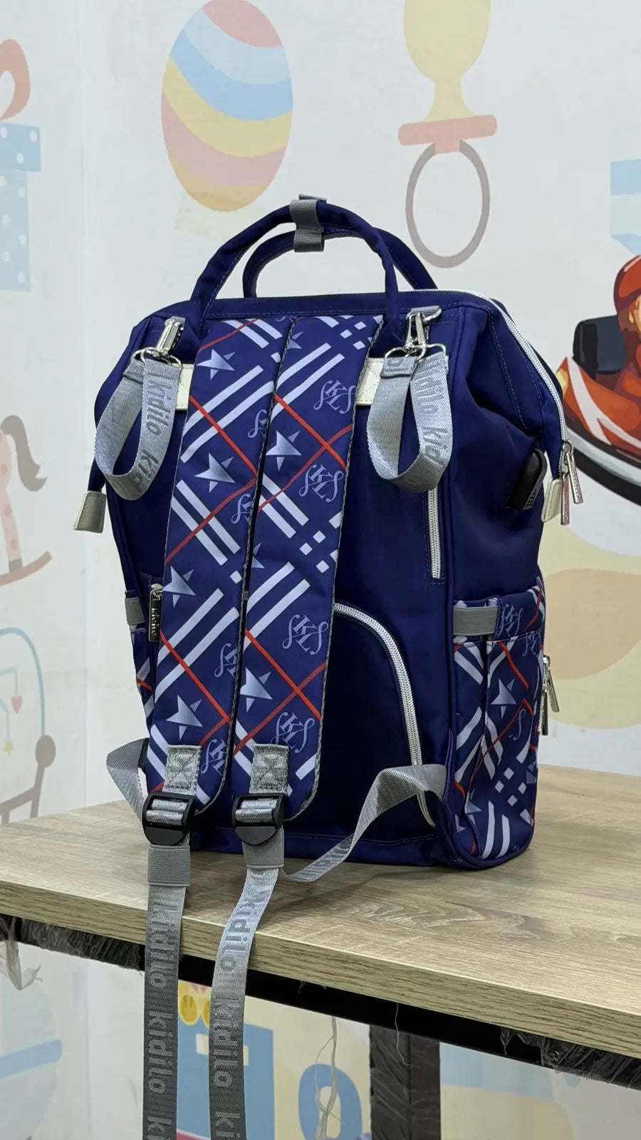 Kidilo Plaid-Print: blue rear view on wooden table showing straps and hanging loops.