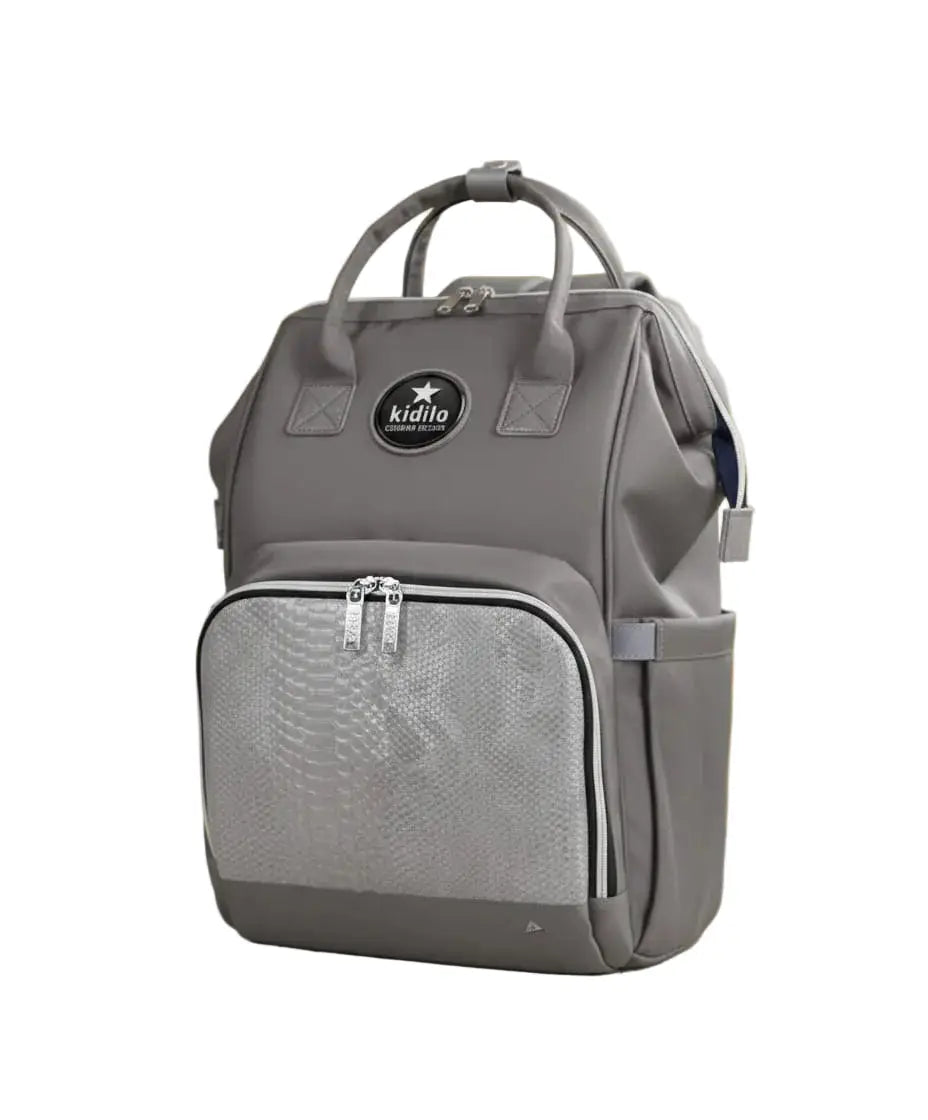 Kidilo X001: Grey diaper backpack from the front with top handles, zip pocket and side pockets.