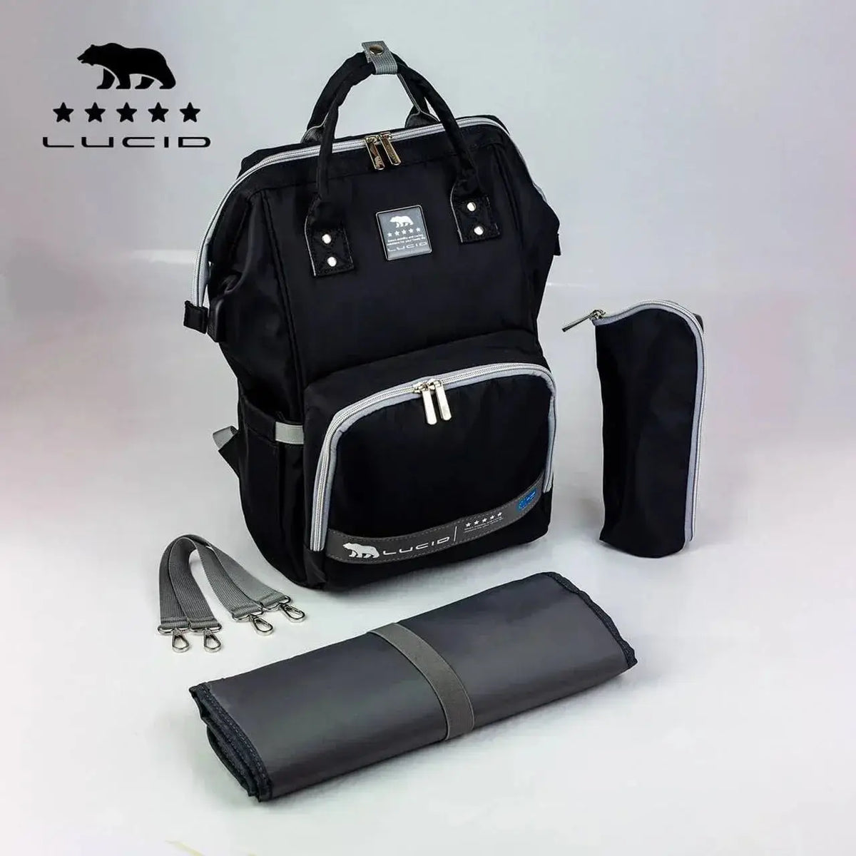 Lucid diaper backpack – black USB bag and accessory layout with Lucid logo on white