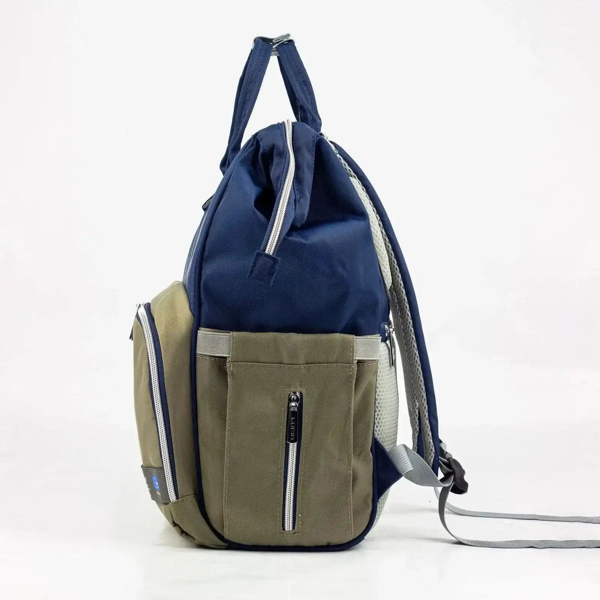 Lucid diaper backpack – navy side profile with olive pocket and grey shoulder straps