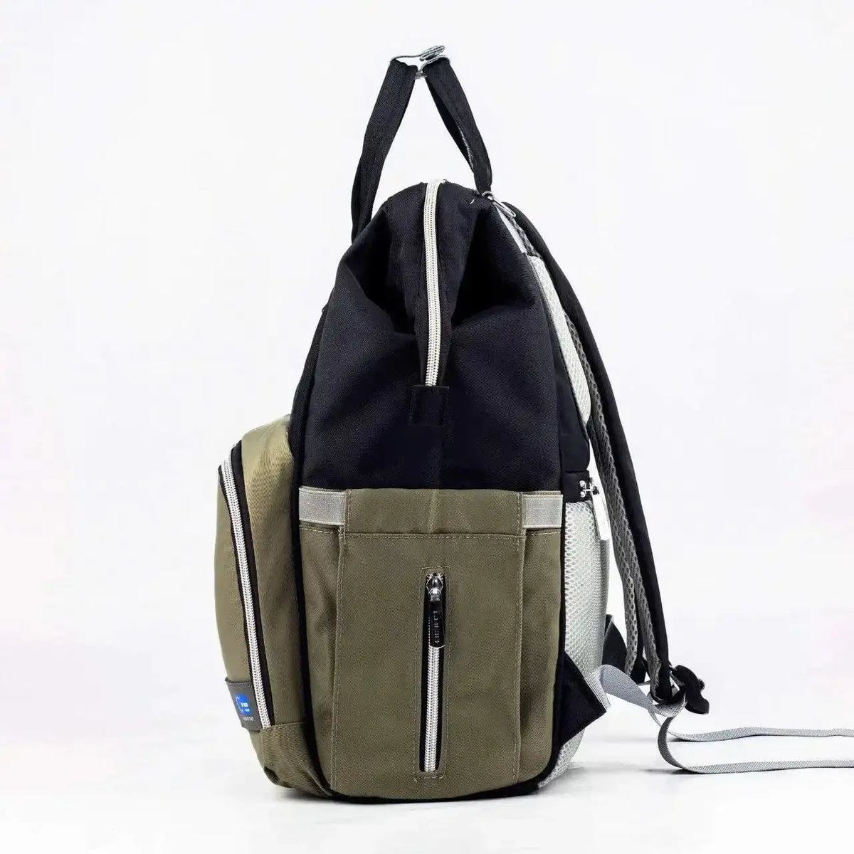 Lucid diaper backpack – side view of black body and olive zipped pocket with grey shoulder straps