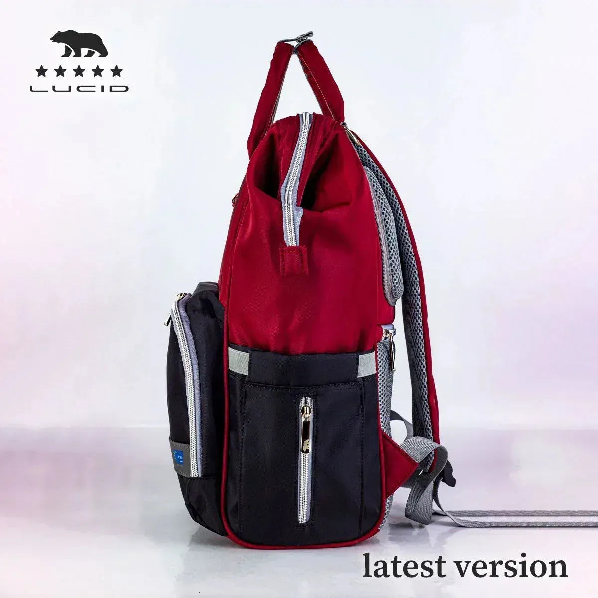 Lucid diaper backpack – side view showing red body, black pocket and grey shoulder strap