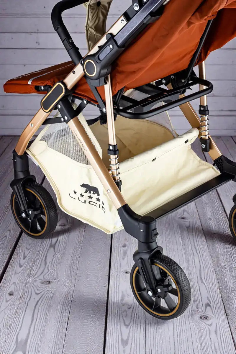 Lucid Easy Go LC2: Side view of orange stroller frame, spring and lower basket