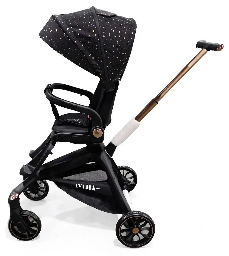 X6 black baby stroller in side profile with patterned canopy, padded bumper bar and gold-coloured handle stem.